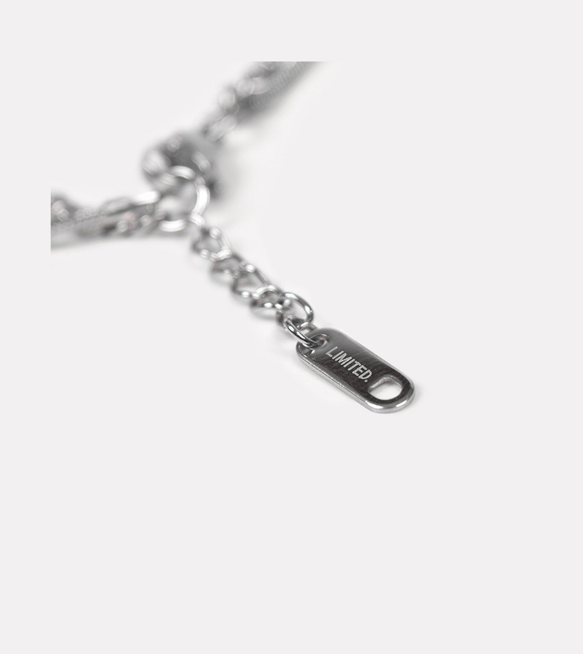 Detailed view of LIMITED. stainless steel double chain bracelet with engraved tag